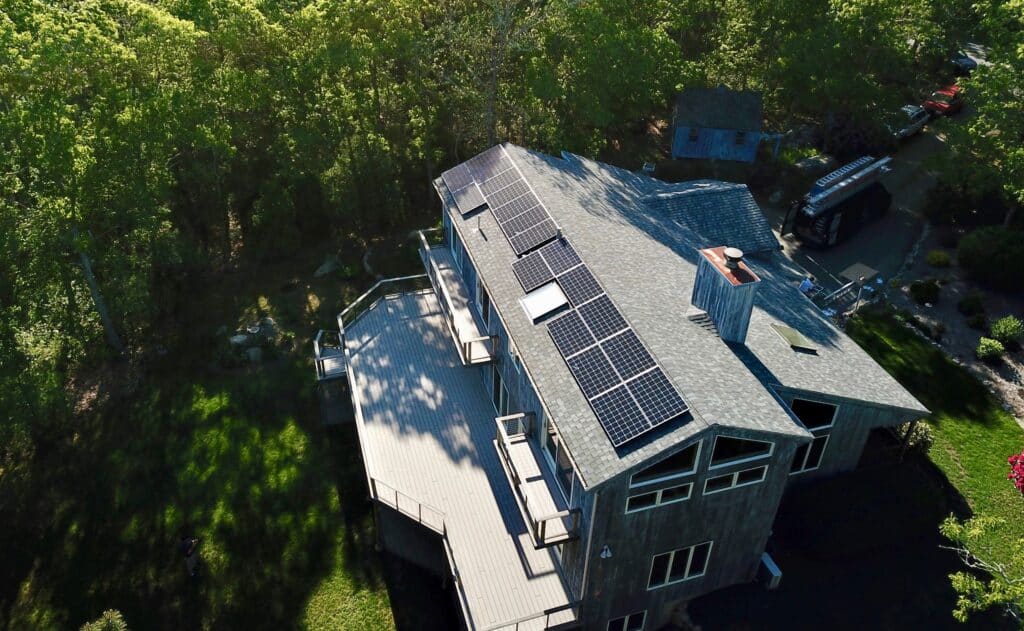 solar panels on roof of house surrounded by trees