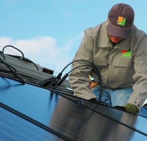 My Generation Energy's solar installer connecting microinverters on a residential rooftop solar installation in Massachusetts