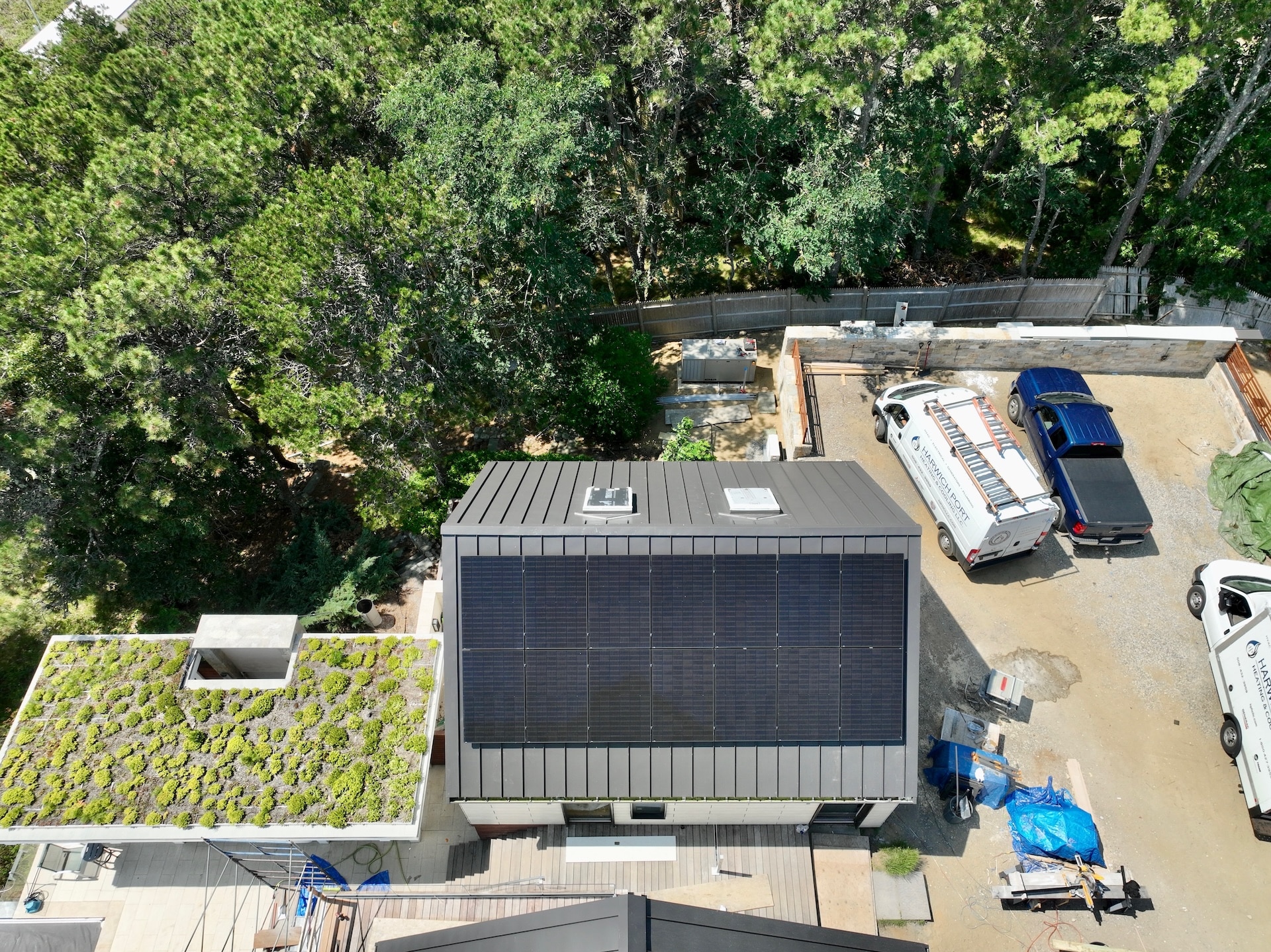 white house with all black solar panel system installed on roof